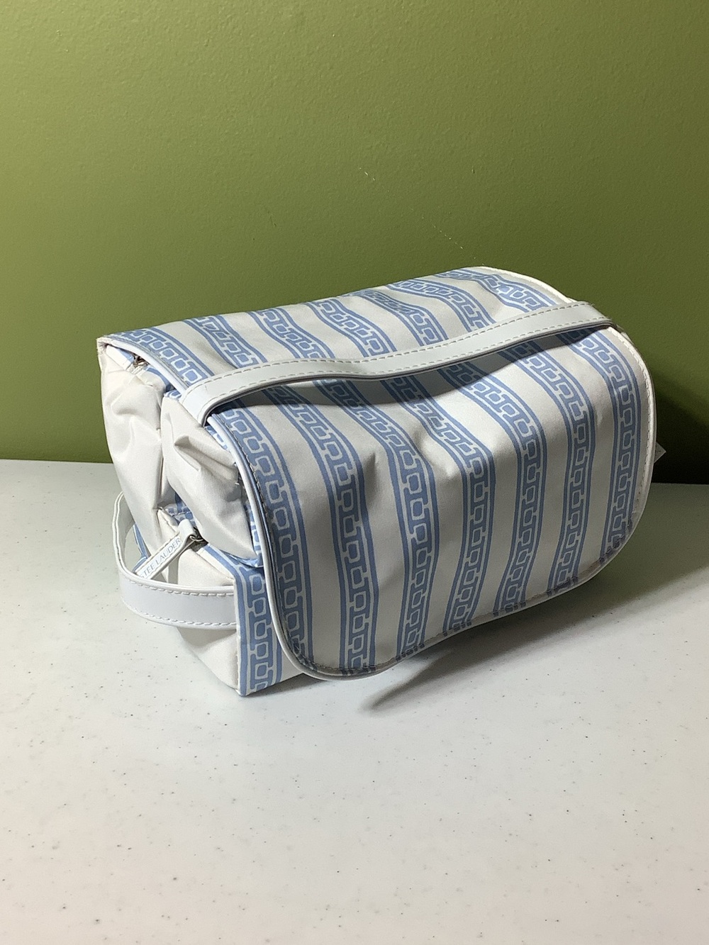 Estée Lauder white and blue stripe roll up travel case